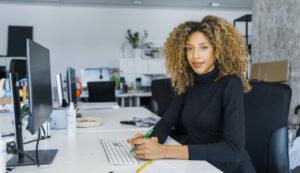 a woman working at a computer desk